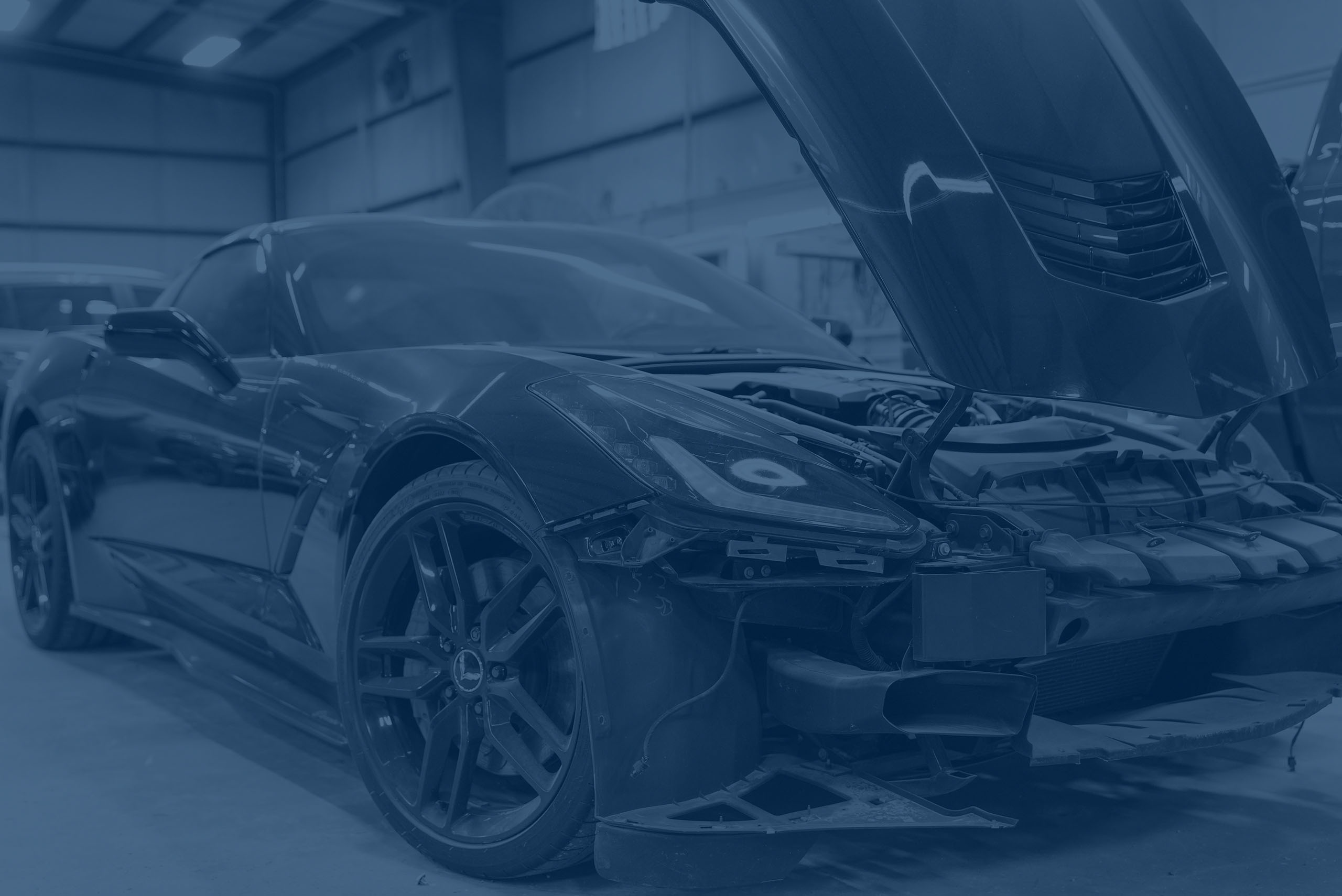 Corvette in garage with hood raised