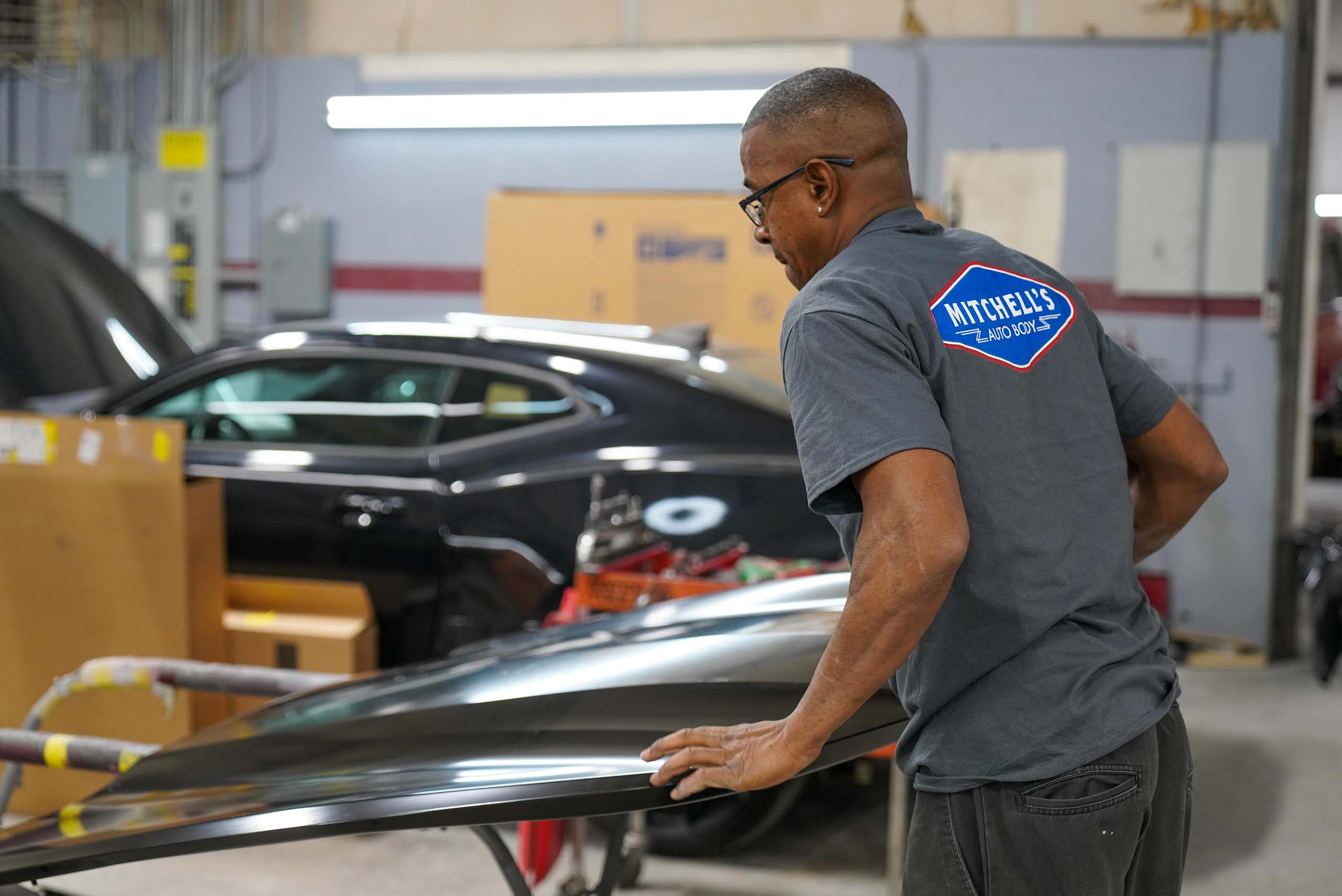 Man fixing a car hood